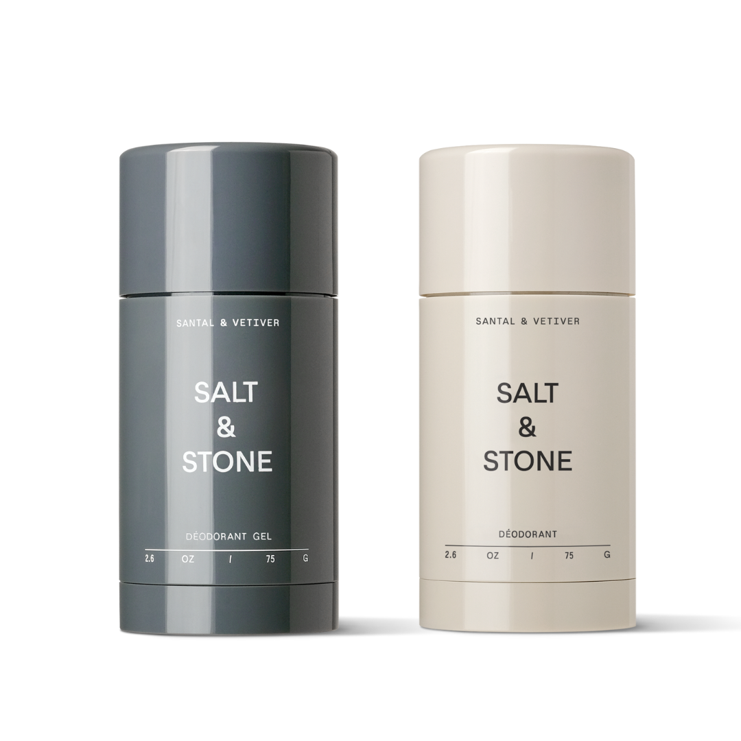 Two deodorant sticks, one labeled 'SALT & STONE', the other one's label is not visible, one is cream-colored and the other one is beige.