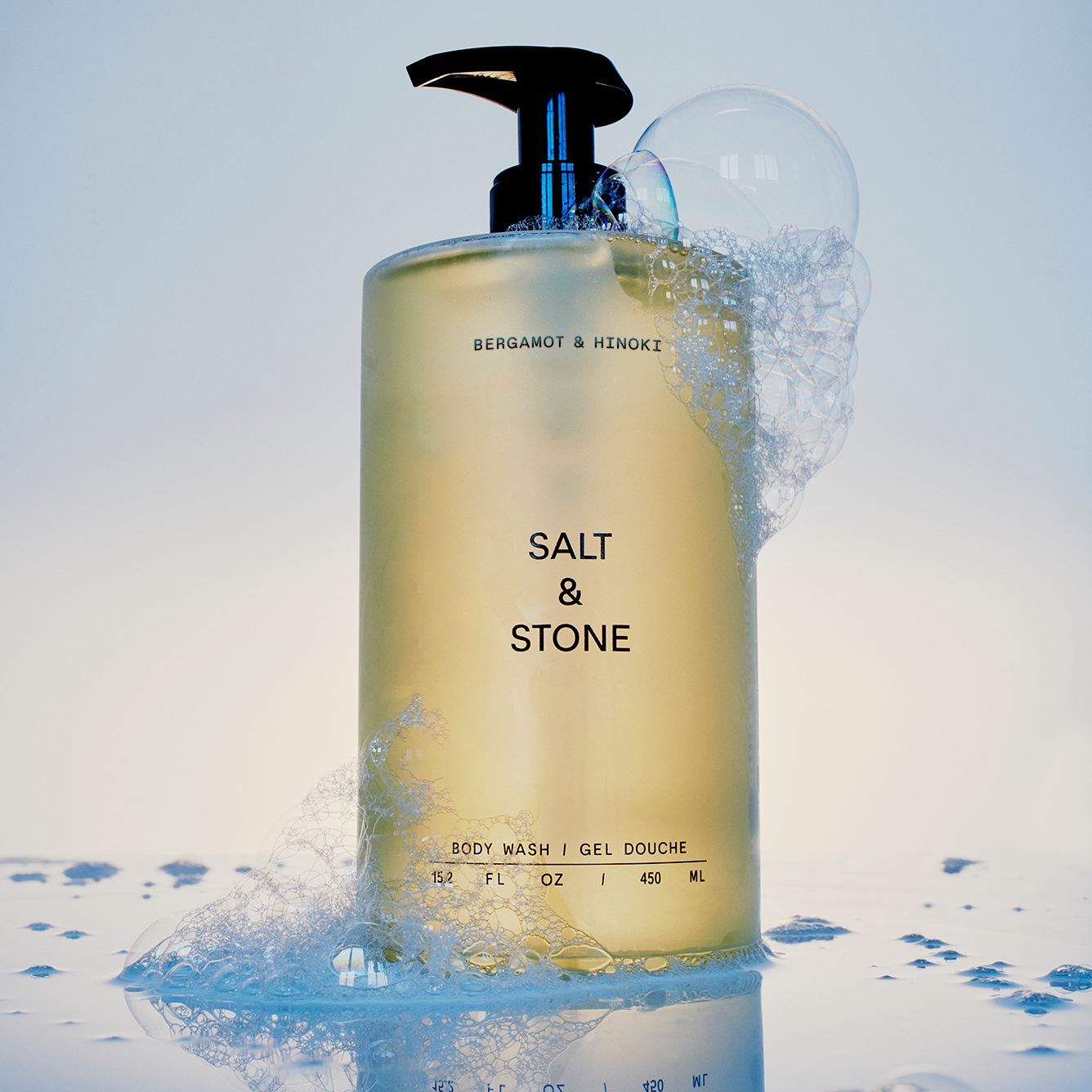 Body wash bottle with 'Salt & Stone' branding on a snowy background
