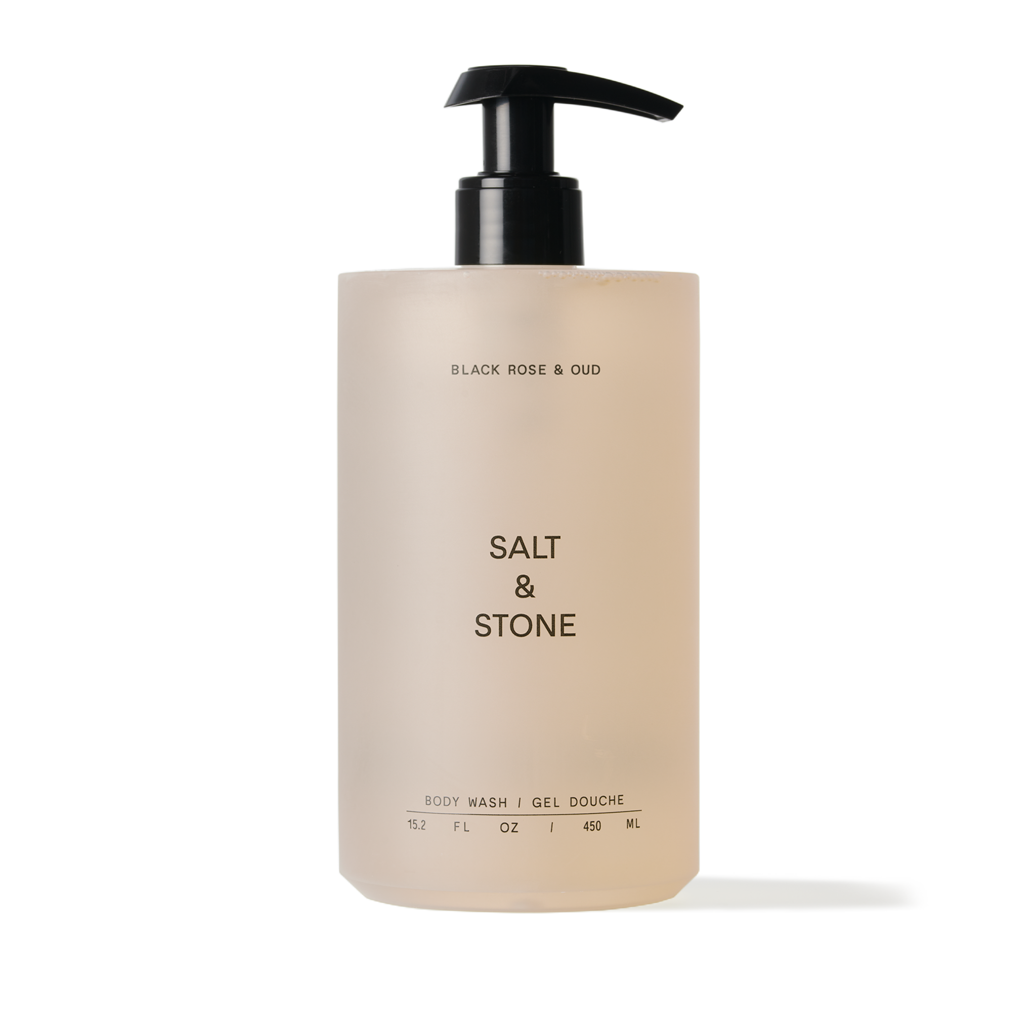 A pump bottle of Salt & Stone body wash with a beige label and black text.
