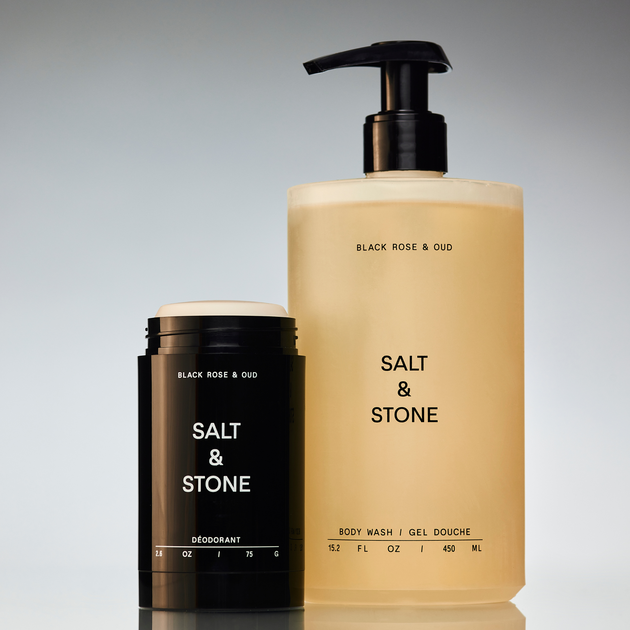 A bottle of Salt & Stone shower gel and a stick deodorant, both with black labeling and branding against a neutral background.