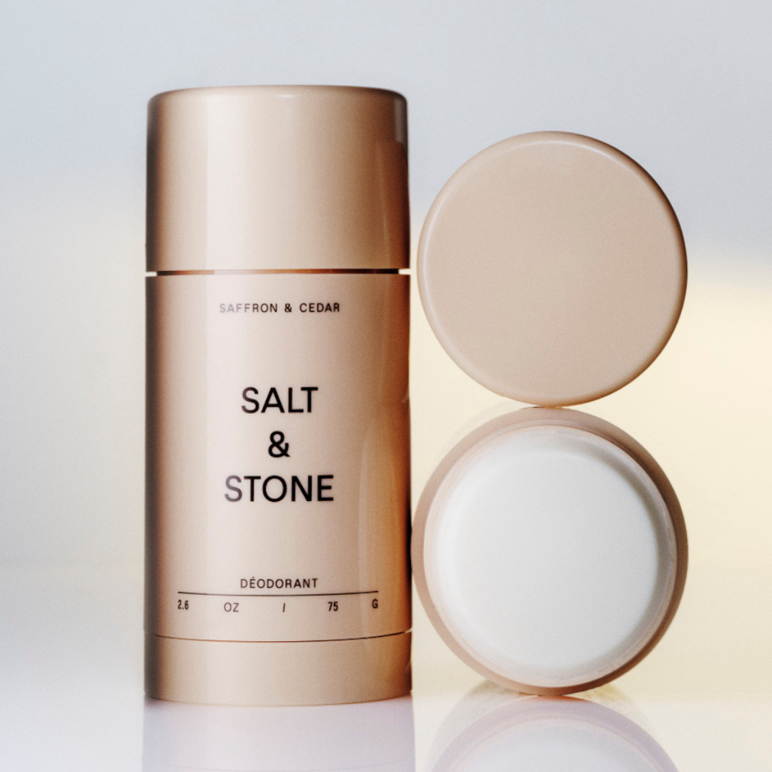 Beige deodorant container with 'Salt & Stone' branding on beige background