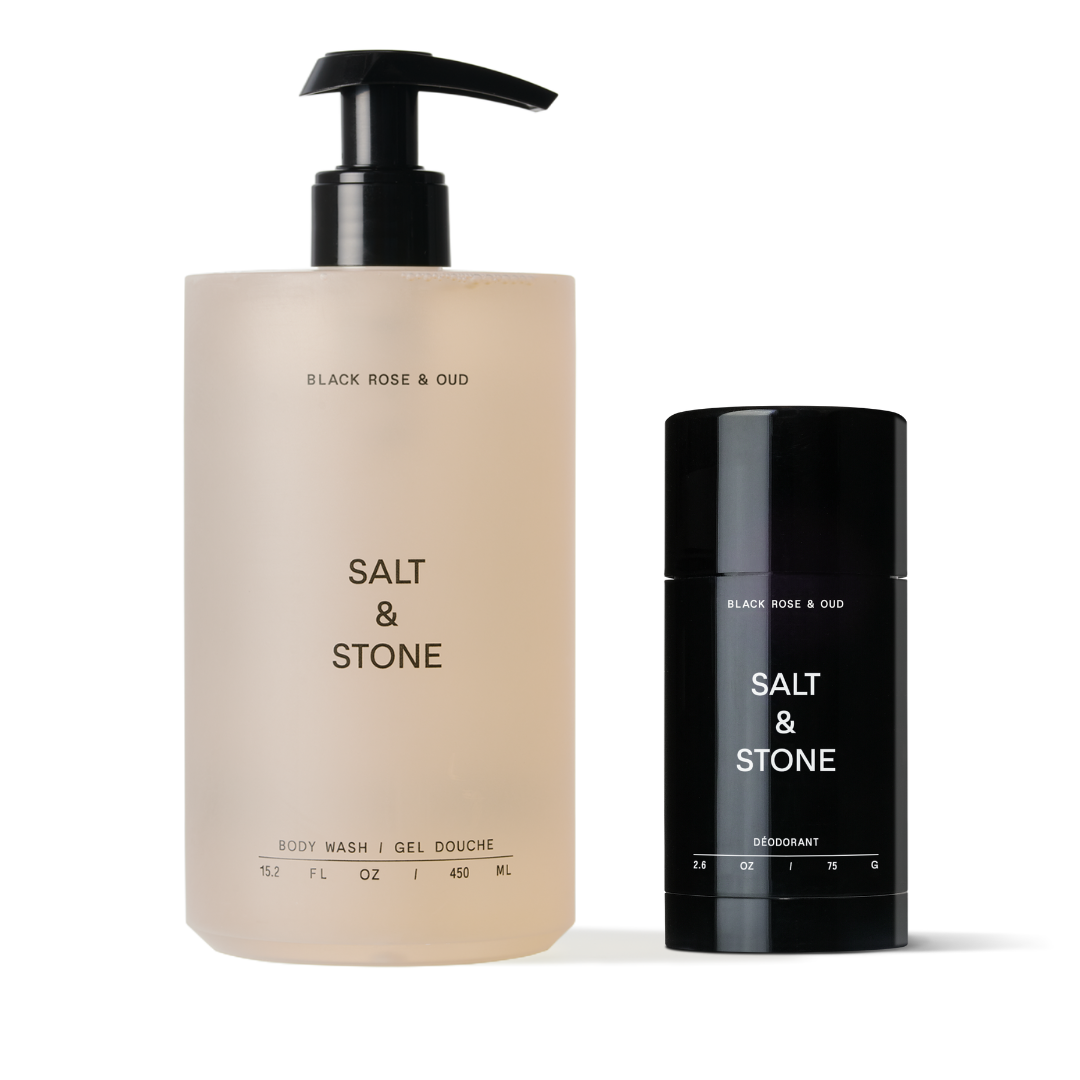 A pump bottle labeled 'SALT & STONE' for shower gel and a stick deodorant bottle also labeled 'SALT & STONE', both with black caps and black labels.
