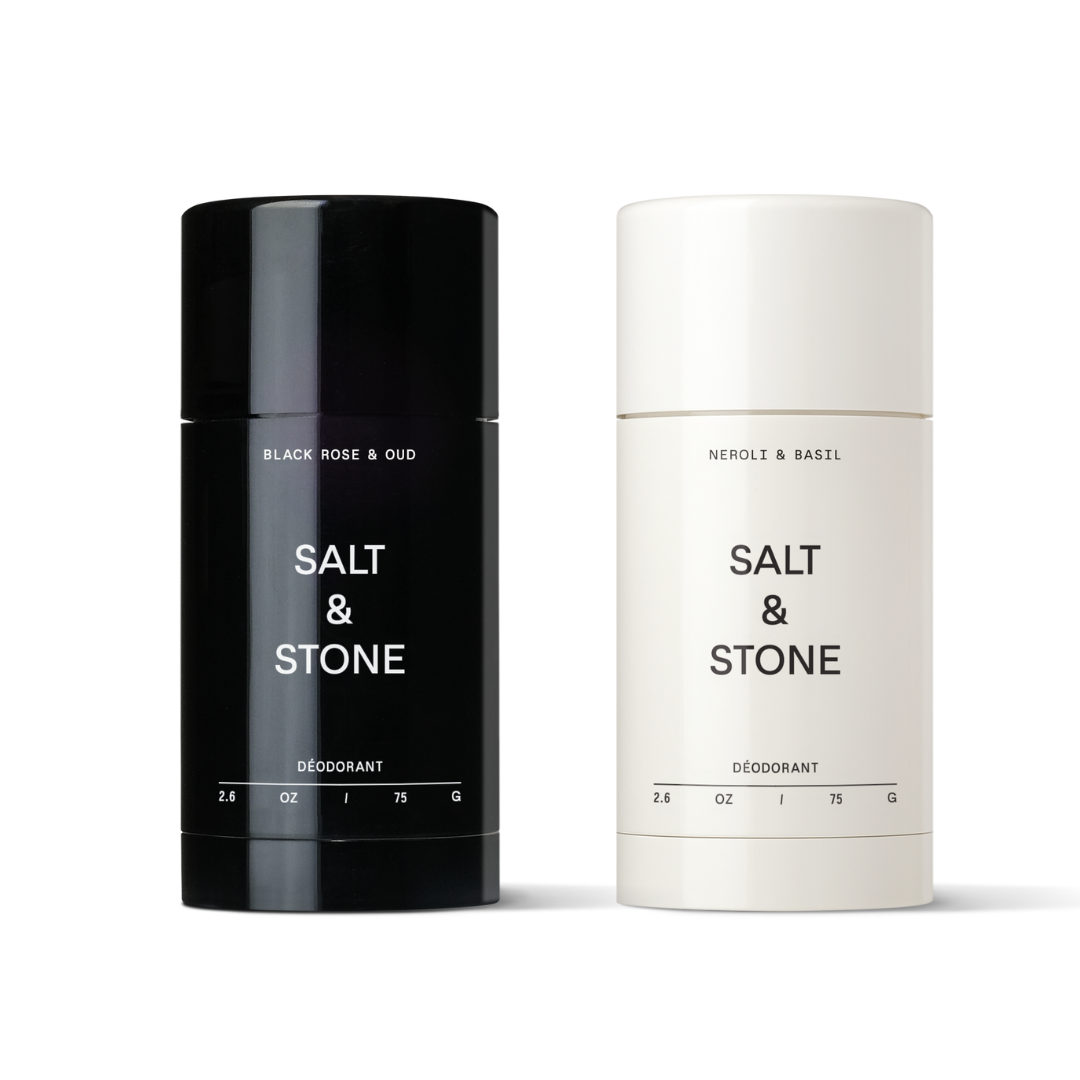 Two stick deodorants from Salt & Stone brand, one labeled Black Rose & Oud, the other Neroli & Basil, both in simple black and white packaging.